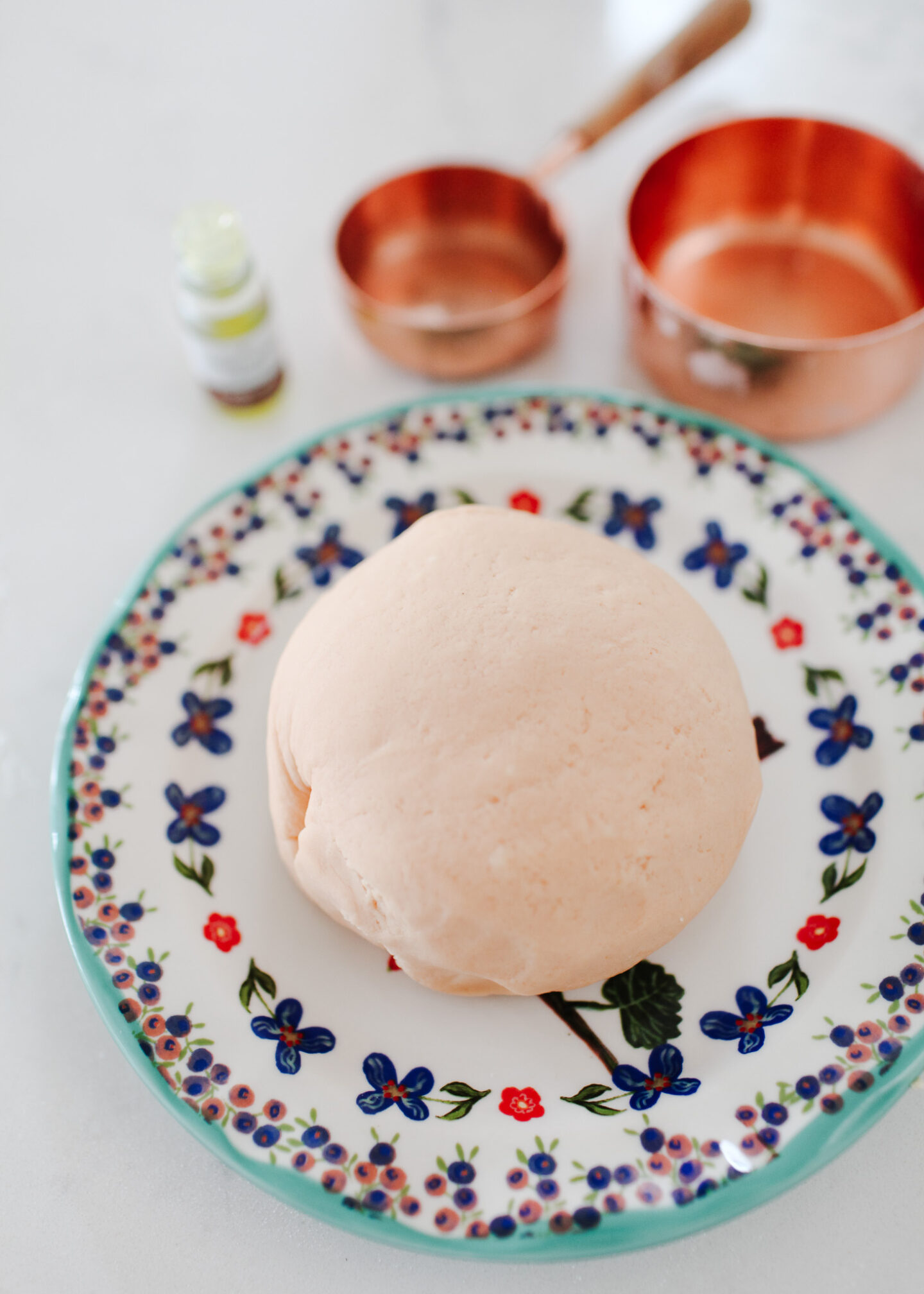 best orange homemade playdough on Anthropologie plate with copper measuring cups