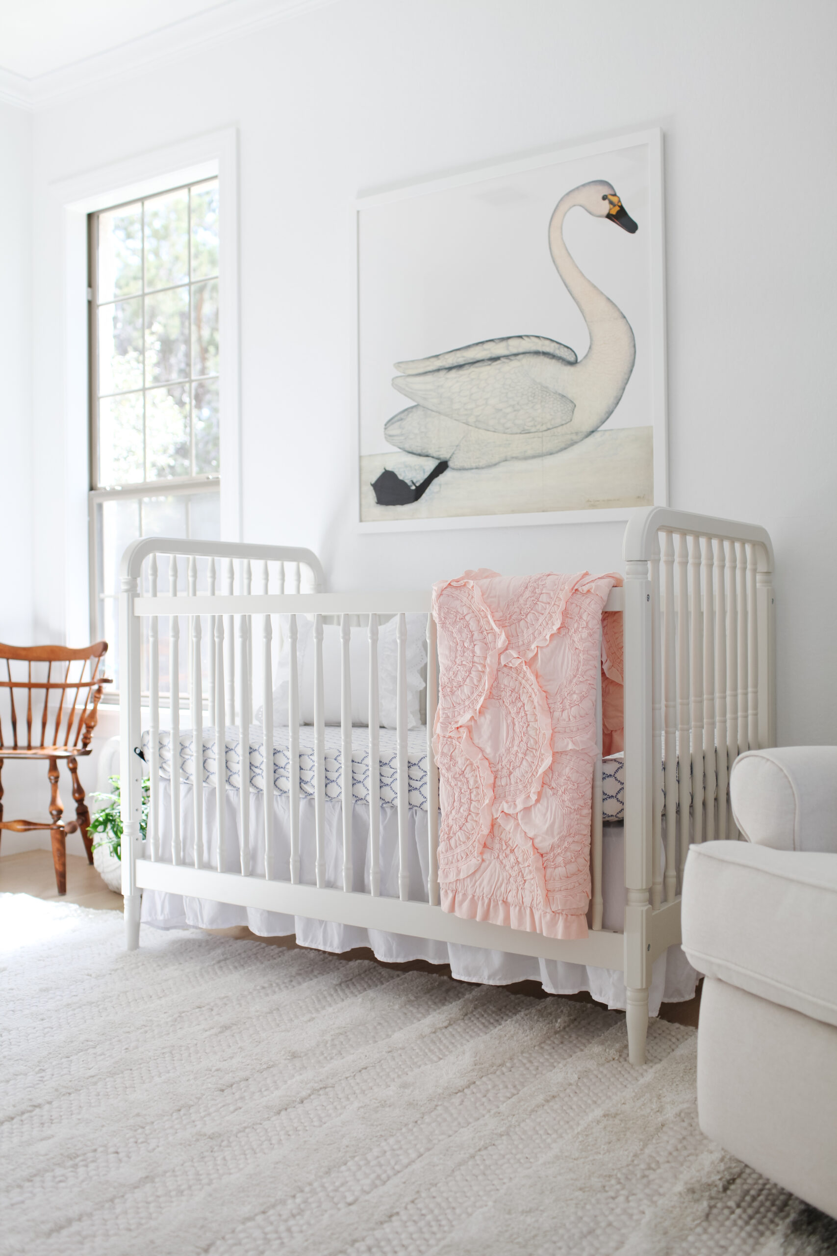 baby girl room wall swan art, crib, rifle paper company blue and white crib sheet, Anthropologie toddler rivulets quilt, vintage chair.
